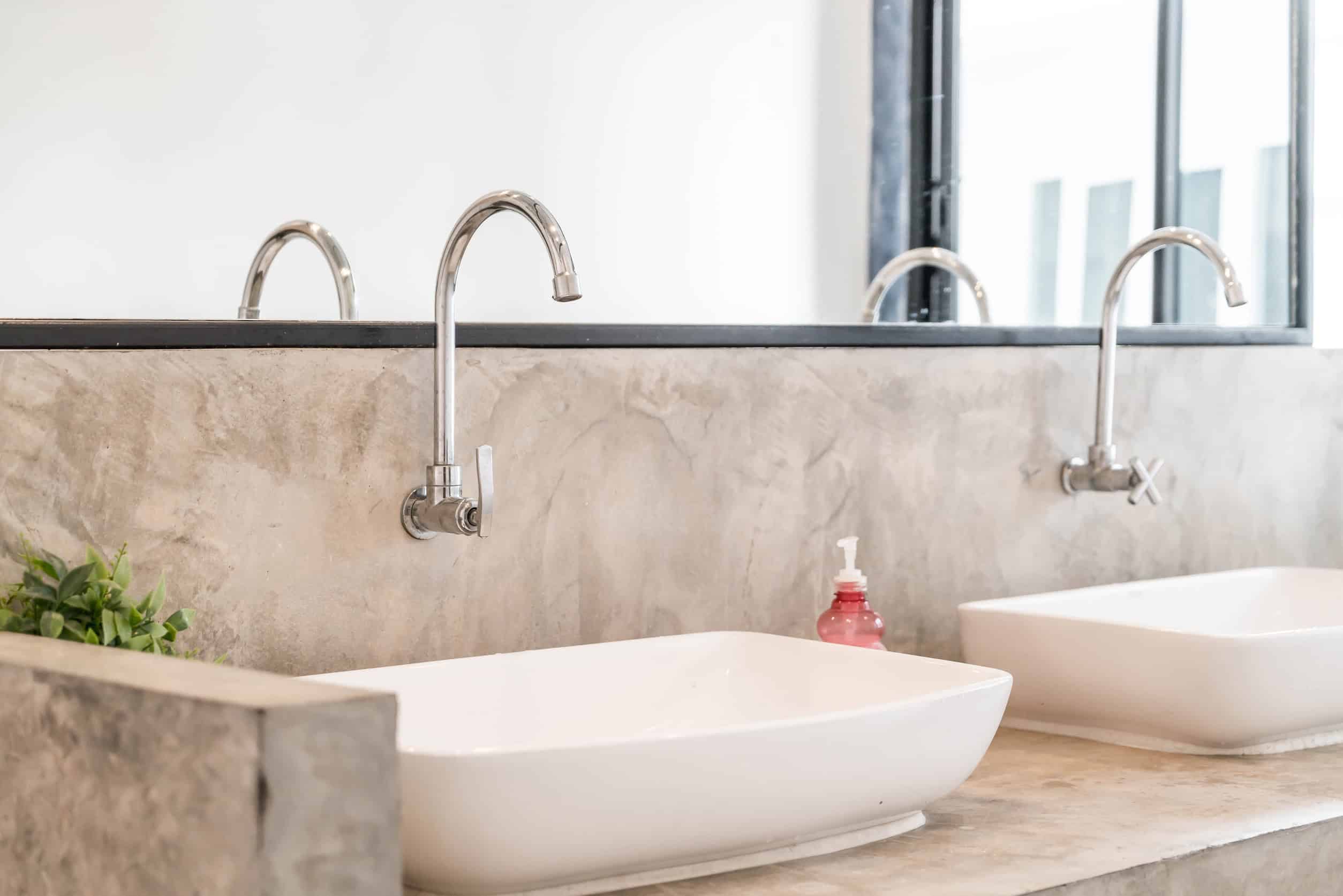 Stone bathroom backsplash with sink and tap